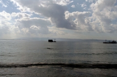 Небольшой островок в центре снимка - все, что осталось от Мушиной башни, которая когда-то охраняла порт со стороны моря. Есть как минимум две версии относительно происхождения ее названия. 
Первая - туда свозили отрубленные в результате казни конечности (то, чем воровали, насиловали, чем убегали, думали) Мухи, сами понимаете, тут как тут... Веселая версия.
Вторая: название - результат ошибки крестоносцев, которые считали, что Акка - библейским Экрон, город филистимлян, в котором стоял храм Вельзевула – Повелителя Мух. Они, якобы, считали, что островок - руины капища. Версия не такая острая, но тоже красивая. Выбирайте.
